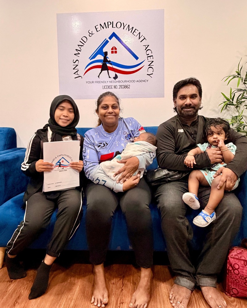 A family and domestic helper during a placement handover at Jans Maid & Employment Agency