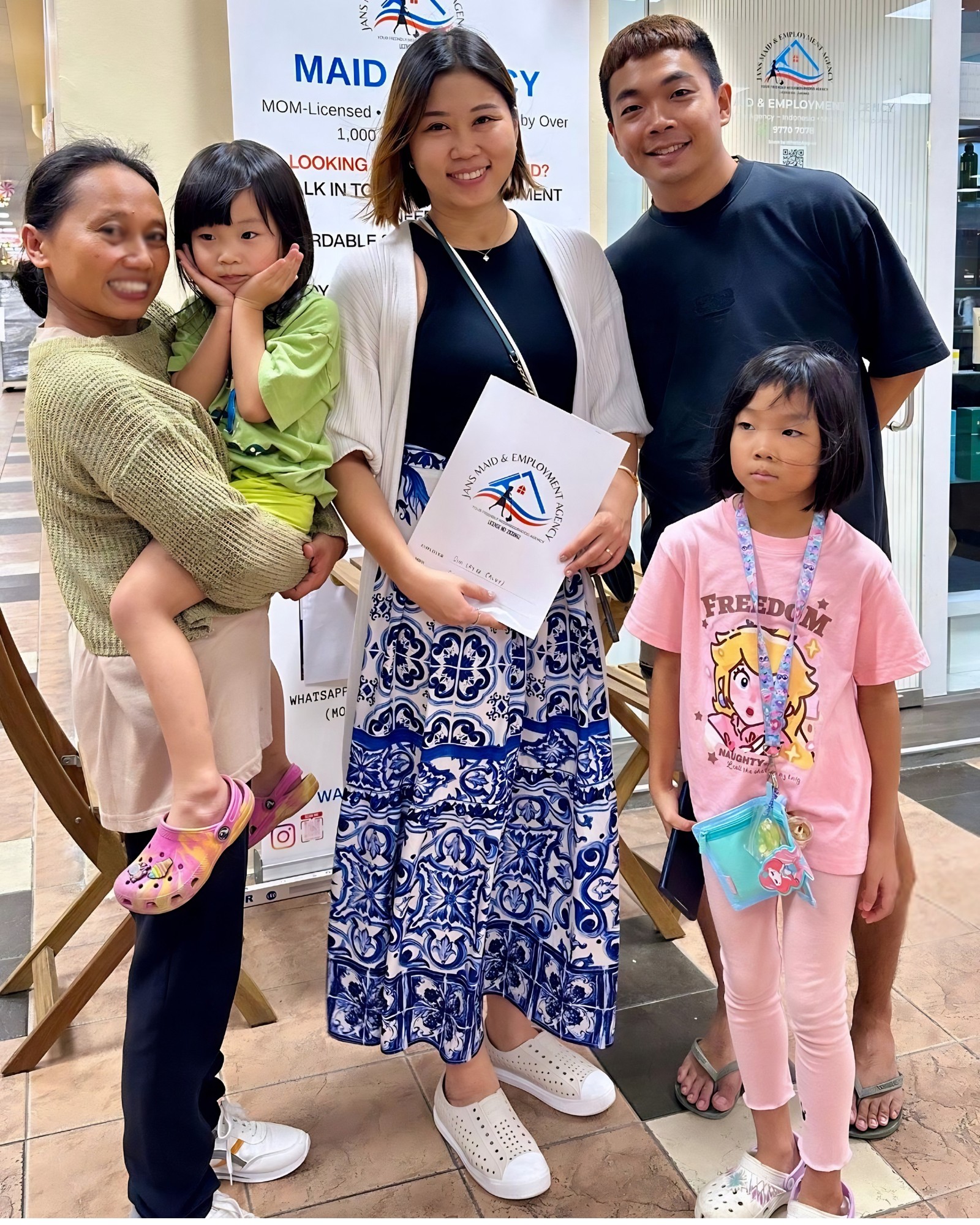 A family with their domestic helper after a placement supported by Jans Maid & Employment Agency at Depot Road